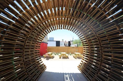 a wooden tunnel in a building with tables and chairs at Retro Studio in the Heart of DTPH - Very Walkable in Phoenix