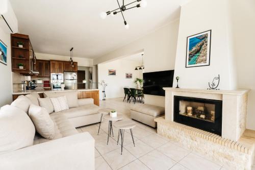 a living room with a couch and a fireplace at Avidianos' -Family Perfect- Residence in Astérion