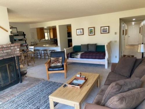 a living room with a couch and a fireplace at Rr-interlaken 13 in June Lake