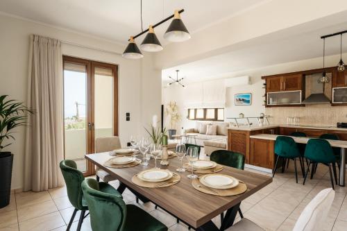 a dining room and kitchen with a table and chairs at Avidianos' -Family Perfect- Residence in Astérion