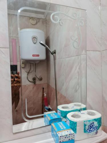 a bathroom with two rolls of toilet paper on a sink at Hello Pyramids inn in Cairo