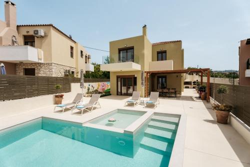 a villa with a swimming pool and a house at Avidianos' -Family Perfect- Residence in Astérion