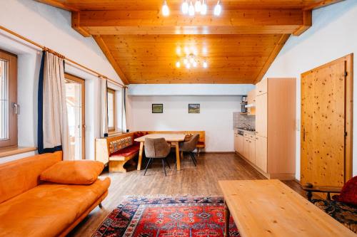 a living room with a couch and a table at Appart Taverne in Mayrhofen