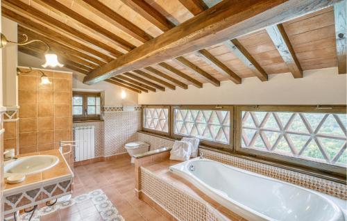 a bathroom with a tub and a toilet and a sink at Villa Tita in Poppi