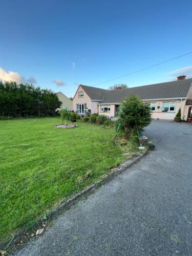 a house with a driveway in front of a yard at Pinebrook BnB En-suite 1 double bed in Killybegs