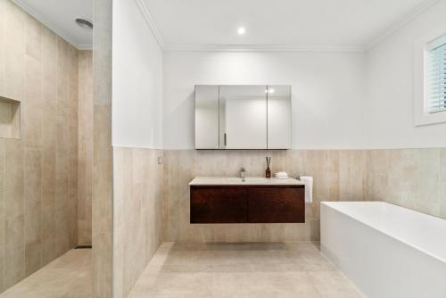 a bathroom with a sink and a bath tub at Nga Roto Retreat - Taupo in Taupo