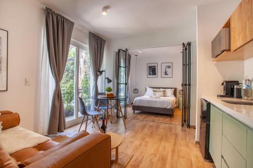 a living room with a couch and a bed at Bright & sweet unit in the heart of Polanco. in Mexico City