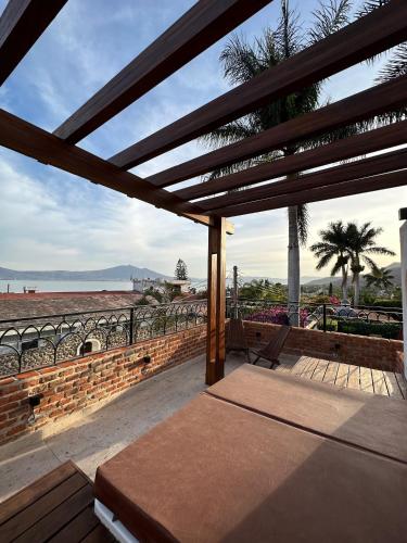 a pavilion with a bed and a view of the ocean at Hotel Lindo Ajijic Bed & Breakfast in Ajijic
