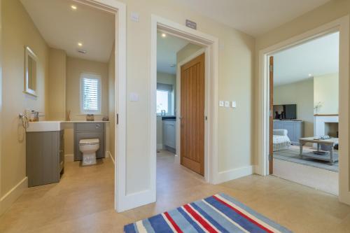 a bathroom with a sink and a toilet in a room at Flint House W in Wighton