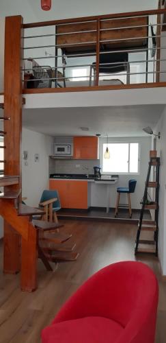 a living room with a loft bed and a red couch at 100 Wonderful House in Bogotá