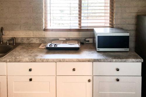 a kitchen with a stove and a microwave on a counter at Patio and Panoramic Desert Views Sedona Getaway! in Sedona