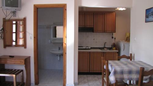 a kitchen with a table and a sink and a table and a table andheastern at Rafaela House in Milína