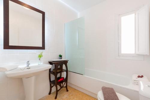 Baño blanco con lavabo y espejo en Happy Place by Fidalsa, en San Miguel de Salinas