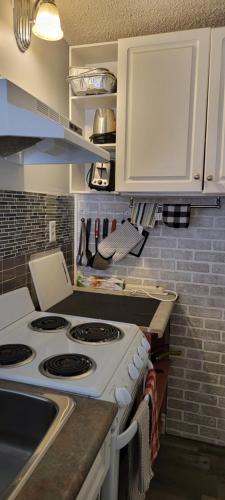 a kitchen with a stove and a counter top at Southview Motel in Westlock