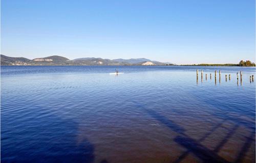 a person on a paddle board in a large body of water at Casa Le Vallette in Massarosa