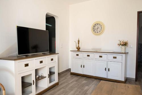 a living room with a tv on a white cabinet at Casa Sabino in Almádena