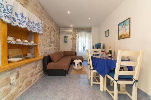 a living room with a couch and a table at Apartments by the sea Kastel Novi, Kastela - 21210 in Kaštela