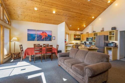 a living room with a couch and a table at Falcons Nest (Upstairs) in Yosemite West