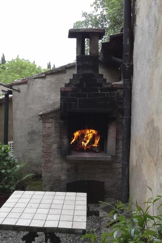 a stone pizza oven with a fire in it at Antica Dimora in Monteroni dʼArbia