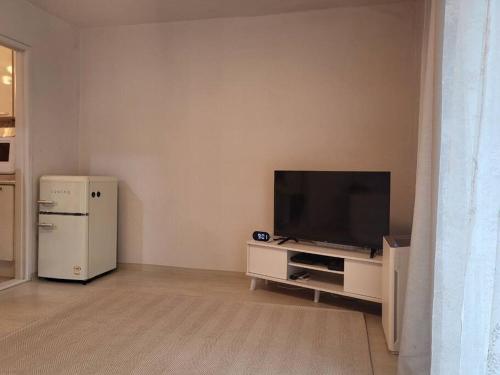 a living room with a television and a refrigerator at 10 mins from Nowon Station! Happy House in Seoul