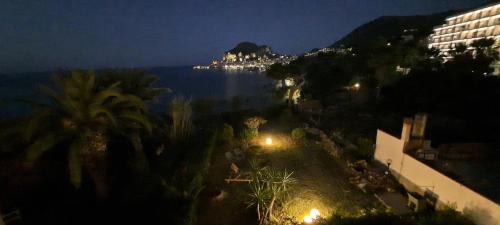 a view of the ocean at night from a building at La Terrazza sul Mare in Cefalù