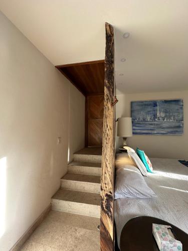 a bedroom with stairs leading up to a bed at Hotel Lindo Ajijic Bed & Breakfast in Ajijic