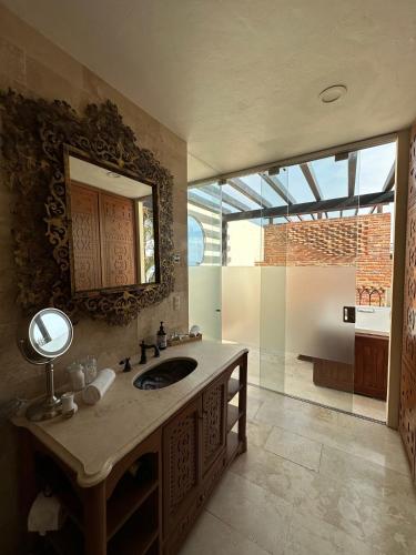 a bathroom with a sink and a mirror at Hotel Lindo Ajijic Bed & Breakfast in Ajijic
