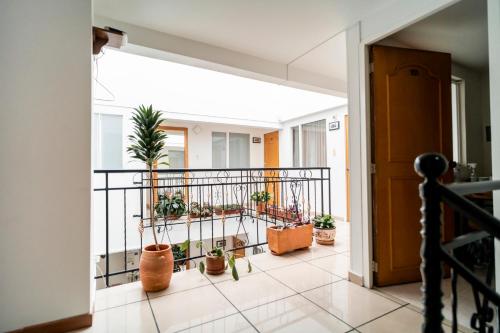 an open hallway with potted plants on a balcony at 100 Wonderful House in Bogotá