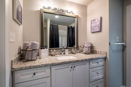 a bathroom with a sink and a mirror at 1 Galleria Downtown 3BR- Free Parking in Houston