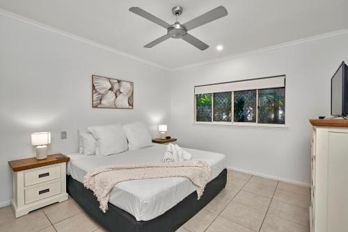 a bedroom with a bed and a ceiling fan at Arlington Apartments in Clifton Beach