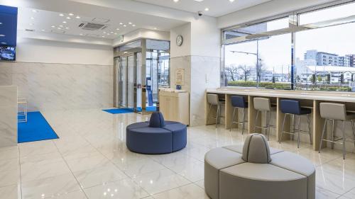 a lobby with a bar and stools in a building at Toyoko Inn Nagano-eki Higashi-guchi in Nagano