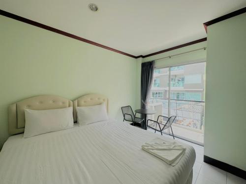 Postel nebo postele na pokoji v ubytování Cocoon Omaya Guest House
