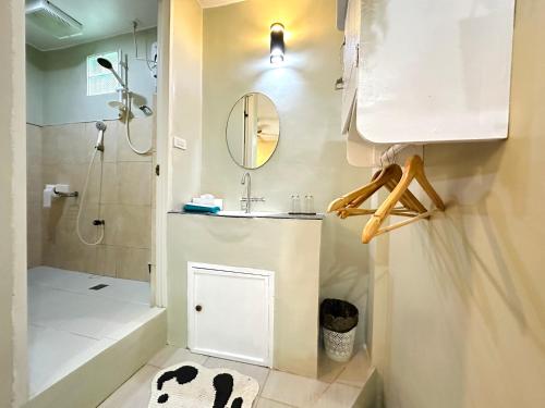 a bathroom with a sink and a shower and a mirror at Panari Lodge El Nido in El Nido