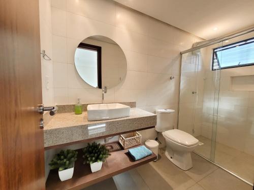 a bathroom with a toilet and a sink and a shower at Residence Farol - Loft 204 in Laguna