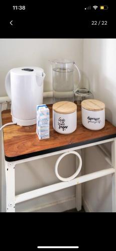 a shelf with three bowls and other kitchen items on it at Private Room in Shared Accommodation in Redcliffe