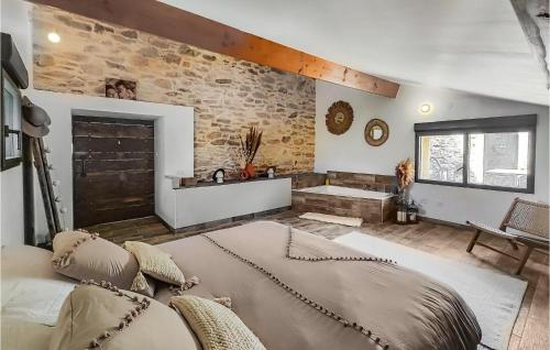 a bedroom with a bed and a stone wall at Beautiful Home In Pardailhan With Wifi in Pardailhan