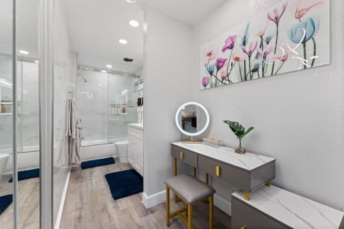 a bathroom with a sink and a mirror at Searenity Suite- Peekaboo Ocean view 1 min walk to Beach in Huntington Beach