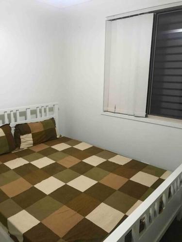 a bedroom with a bed with a checkered floor at Private Room in Shared Accommodation in Redcliffe