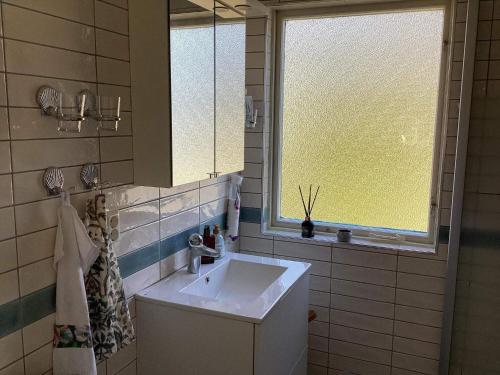 a bathroom with a sink and a window at Holiday home Vingåker III in Vingåker