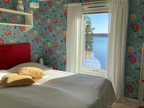 a bedroom with a bed and a large window at Holiday home Vingåker III in Vingåker
