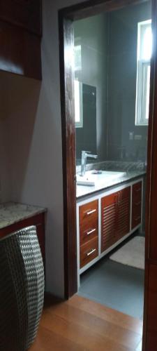 a bathroom with a sink and a mirror at Camiguin Lanzones Resort in Mambajao