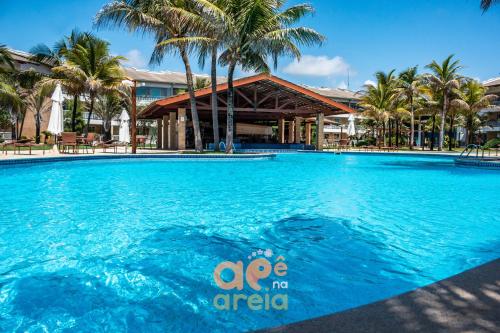 a large swimming pool in front of a resort at O Apê na Areia é seu refúgio pertinho do Beach Park in Aquiraz