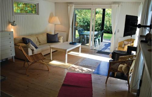 a living room with a couch and a table at Holiday Home Strandkrogen Ix in Dronningmølle