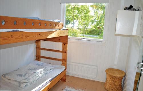 ein Schlafzimmer mit einem Etagenbett und einem Fenster in der Unterkunft 3 Bedroom Pet Friendly Home In Dronningmlle in Dronningmølle