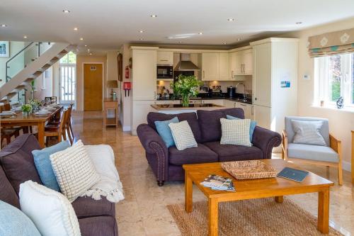a living room with two couches and a table at Trewhiddle Retreat V8 by Together Travel - Luxury 3-Bedroom Villa in St Austell