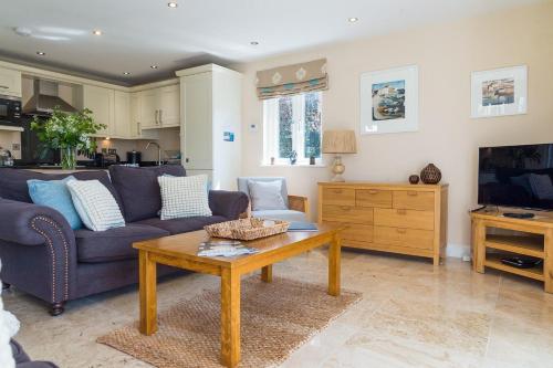 a living room with a couch and a coffee table at Trewhiddle Retreat V8 by Together Travel - Luxury 3-Bedroom Villa in St Austell
