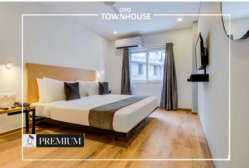 a hotel room with a bed and a window at Townhouse 165 Netaji Road in Ahmedabad