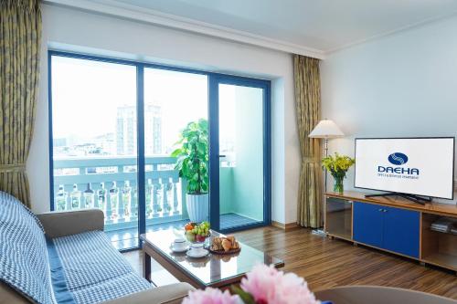 a living room with a couch and a television at Daeha Serviced Apartment in Hanoi