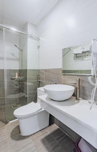 a bathroom with a sink and a toilet and a shower at Lacami Dalat Hotel in Da Lat