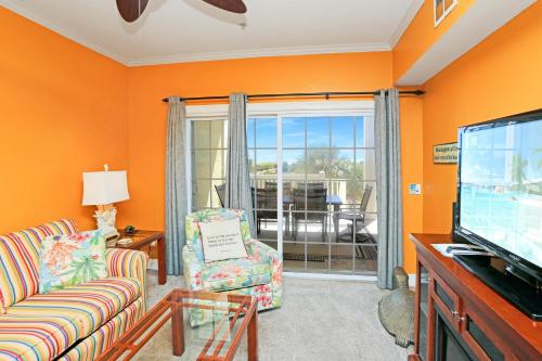 a living room with a couch and a tv at Dunes Club 1C by Pristine Properties Vacation Rentals in Cape San Blas